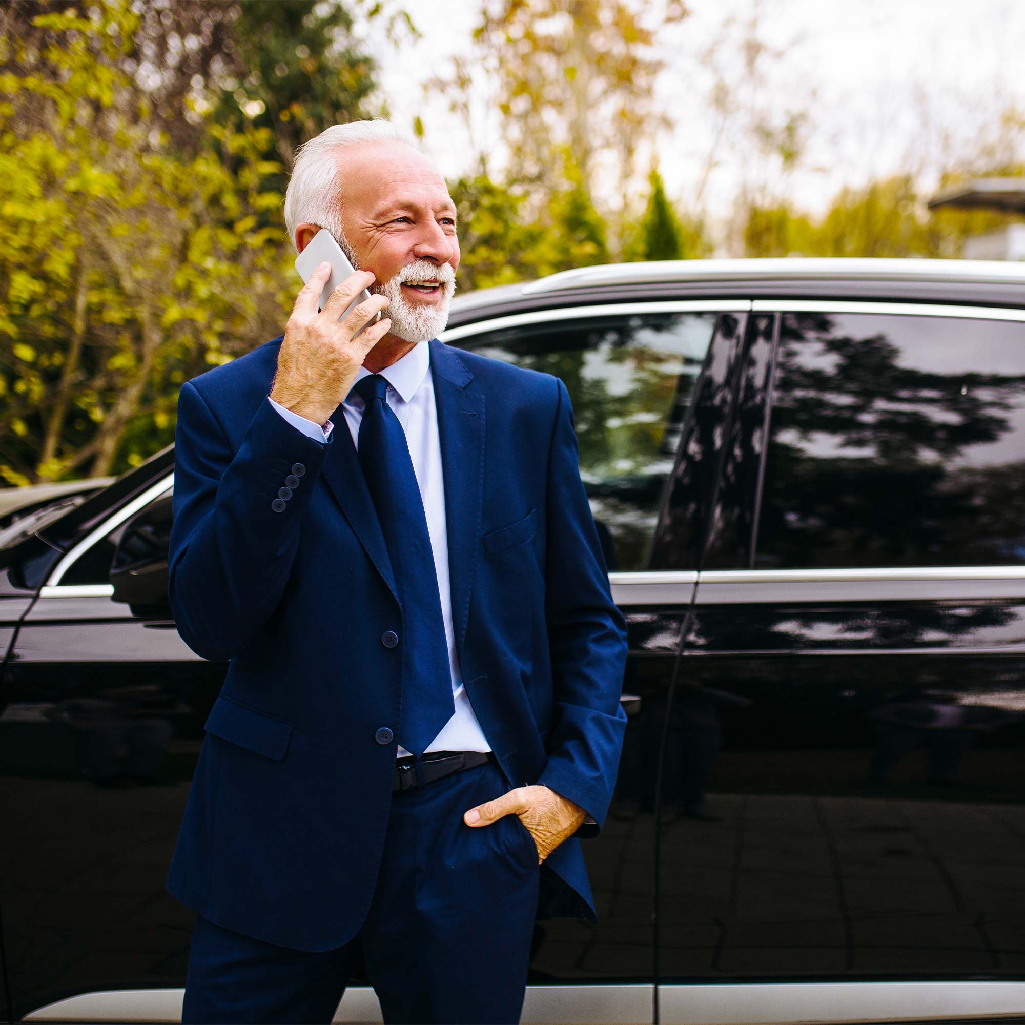 a man in a suit talking on a cell phone