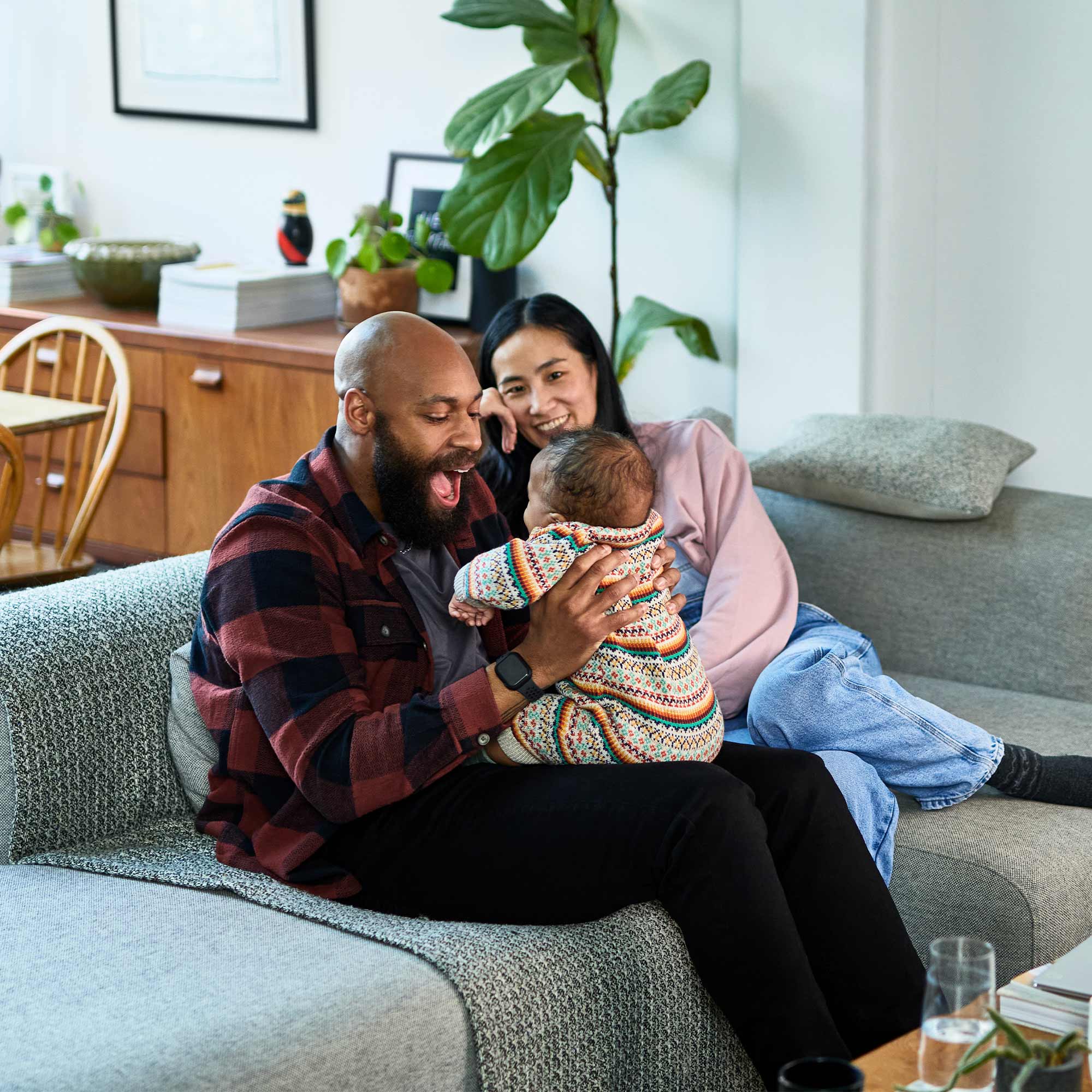 a man and woman holding a baby