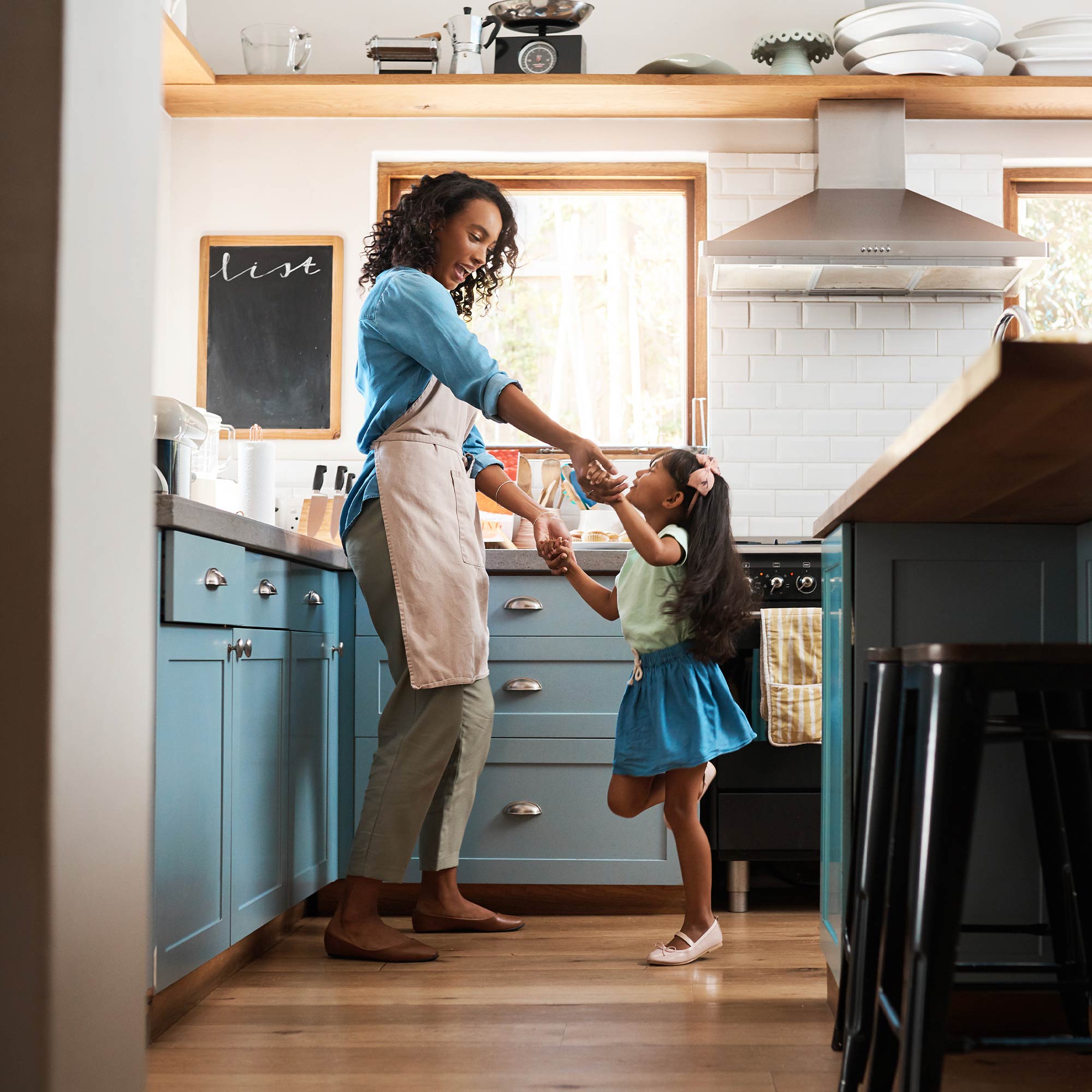 a woman and a child in a kitchen