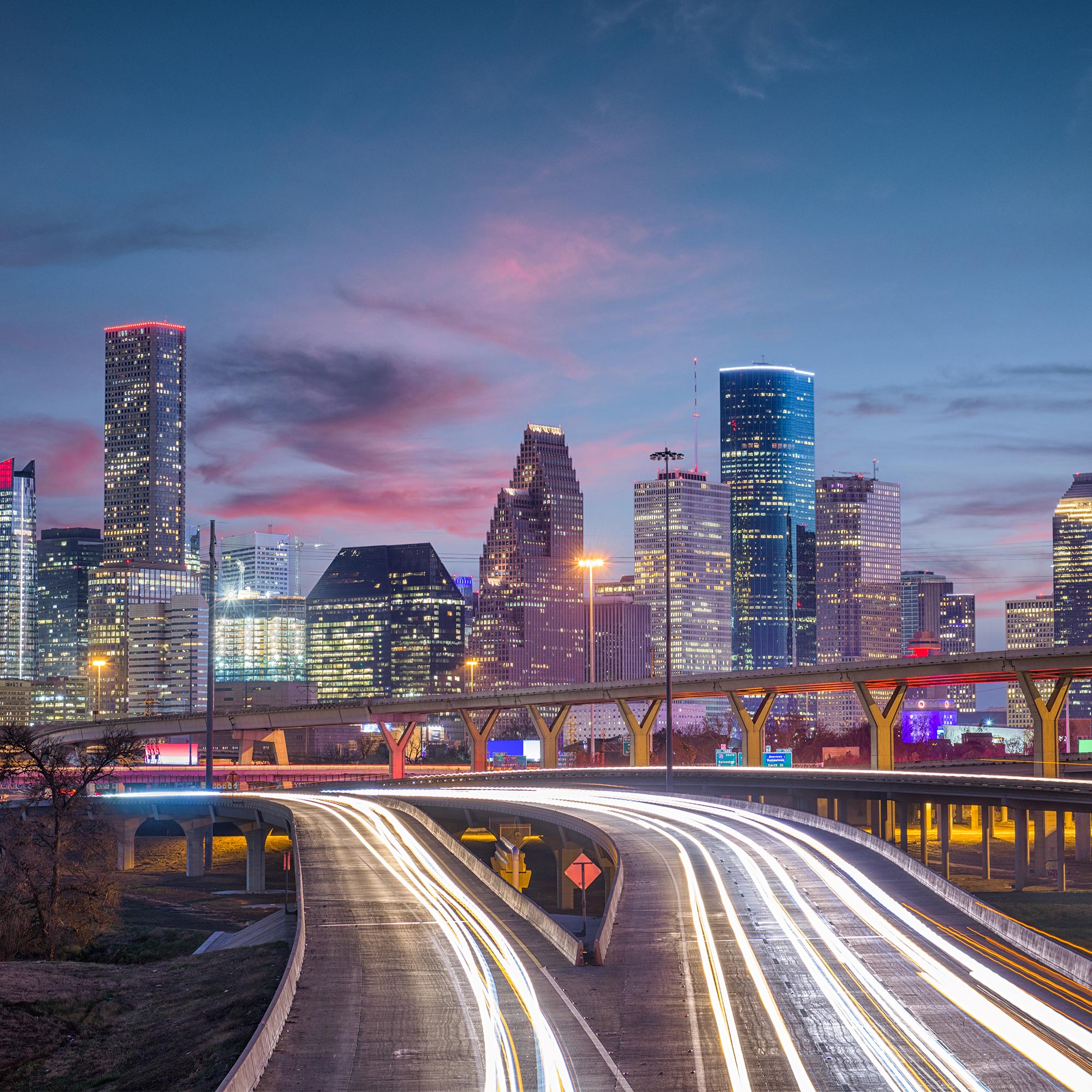 a city skyline with a bridge and a road