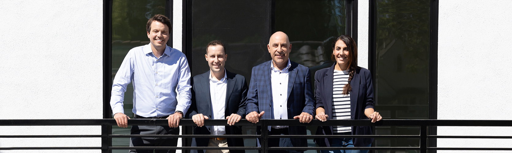 a group of people standing next to a railing