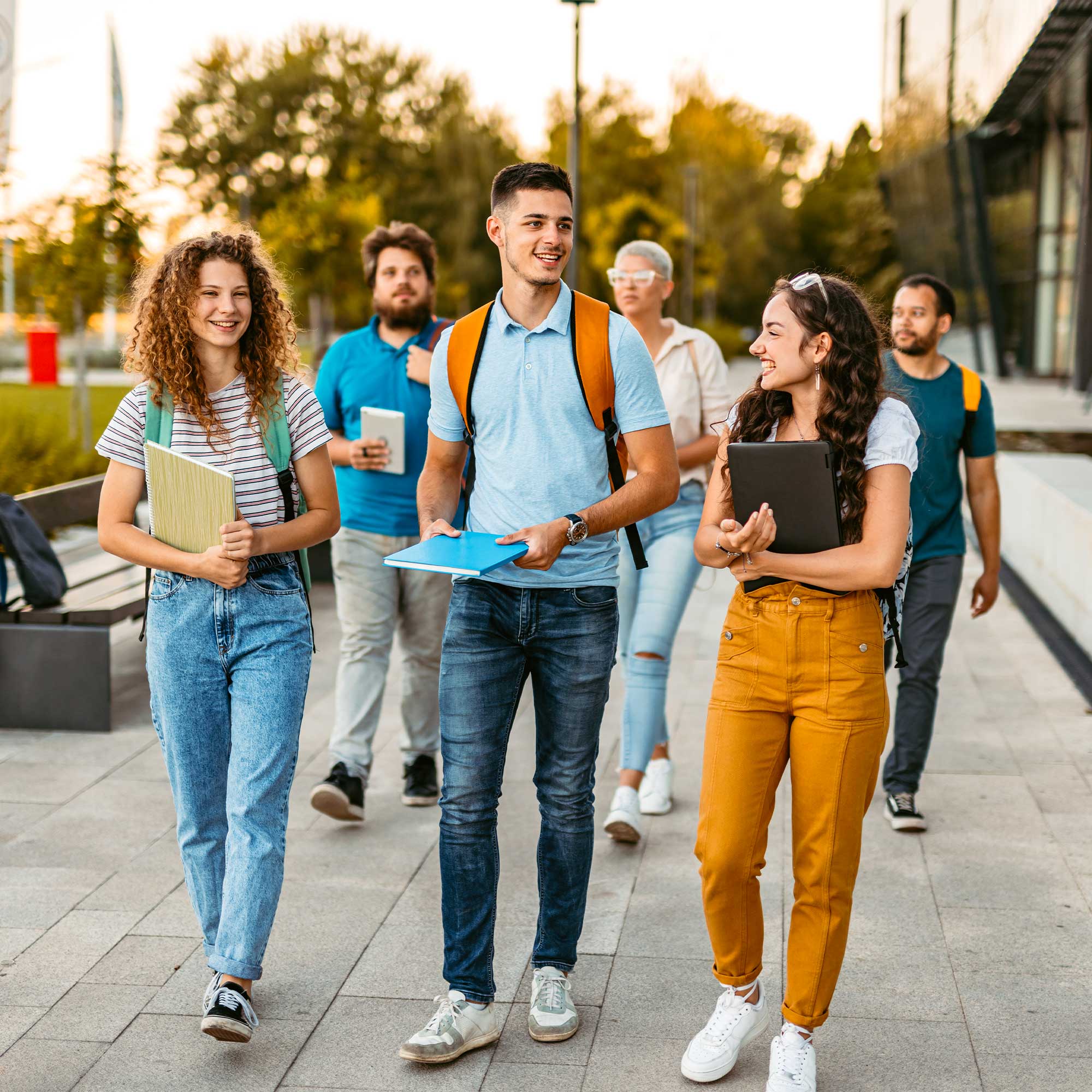 a group of people walking on a sidewalk