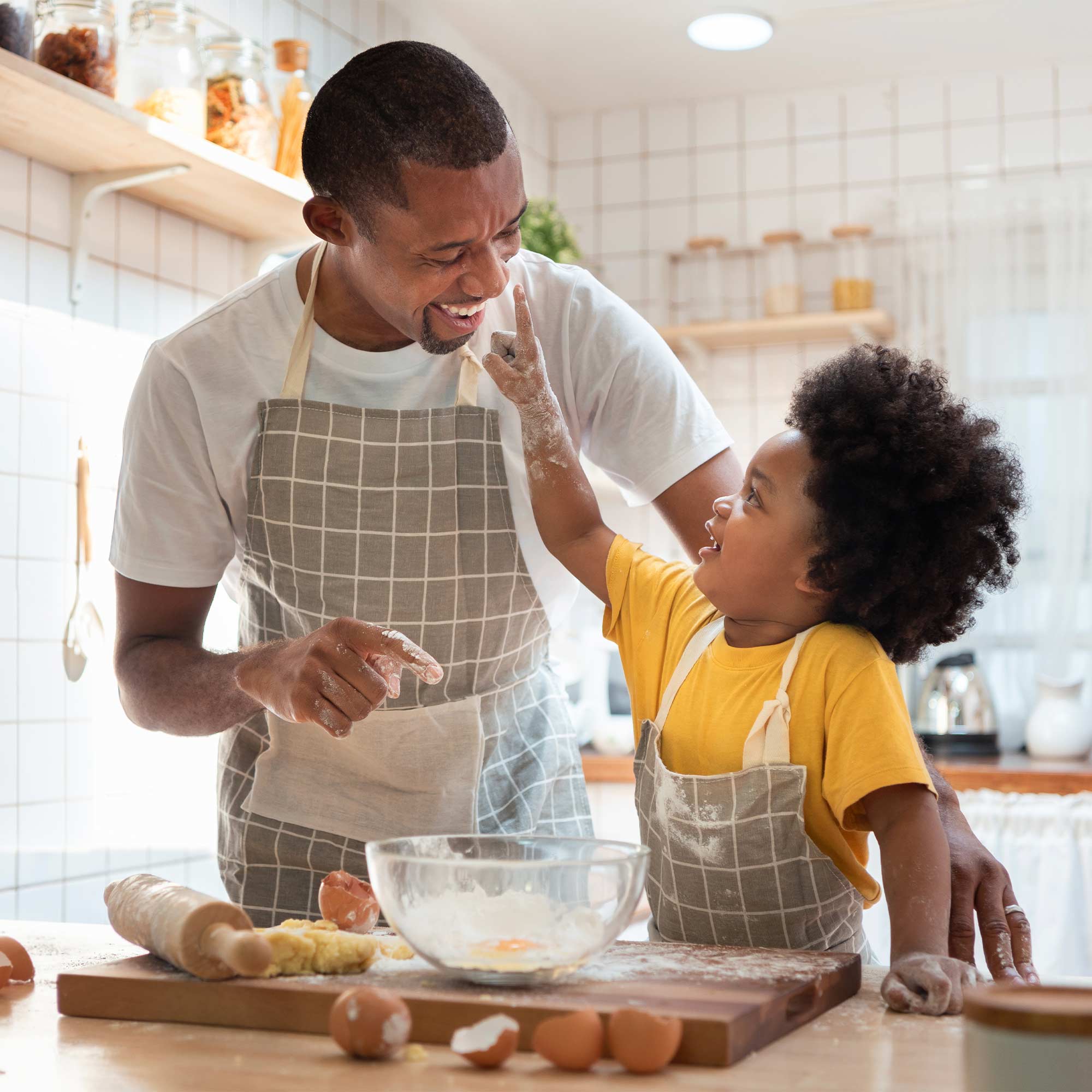 a man and child in the kitchen