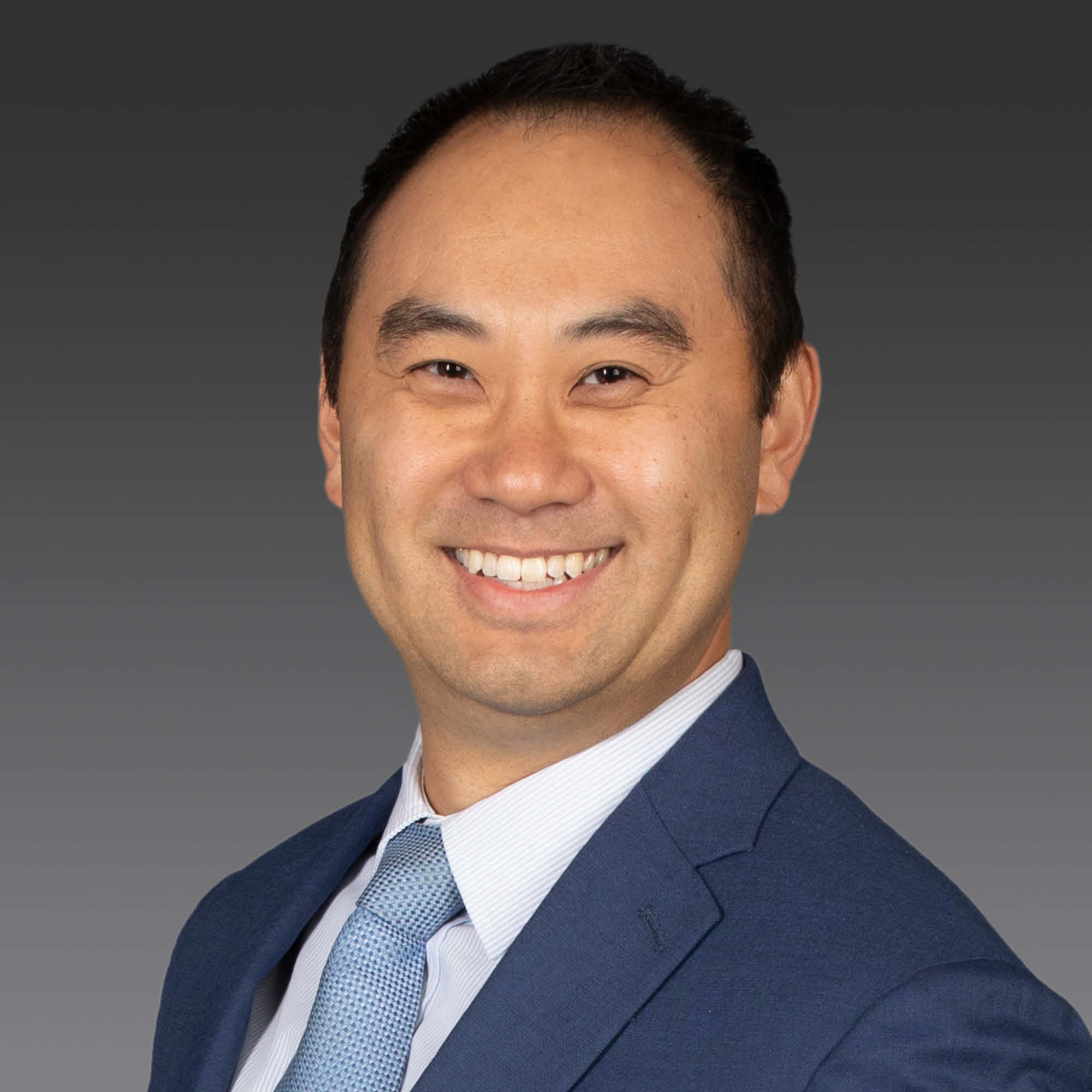 a man in a suit smiling