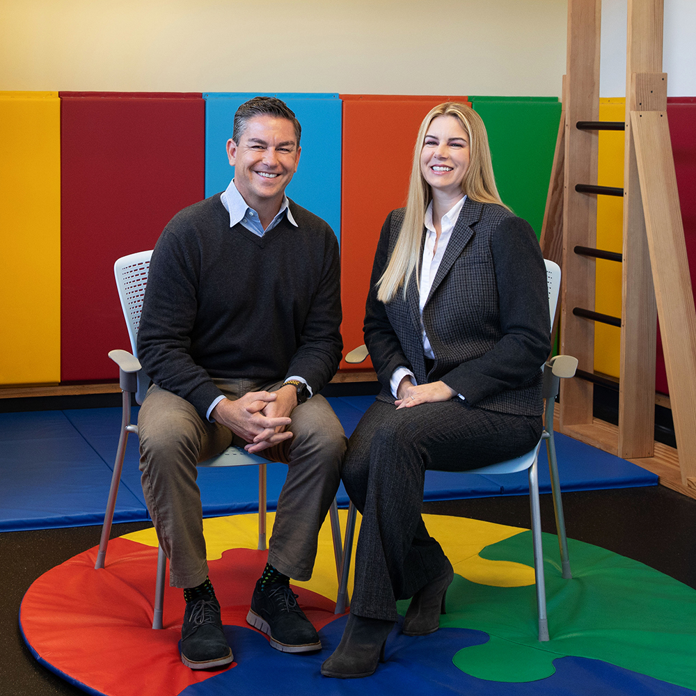 a man and woman sitting on chairs
