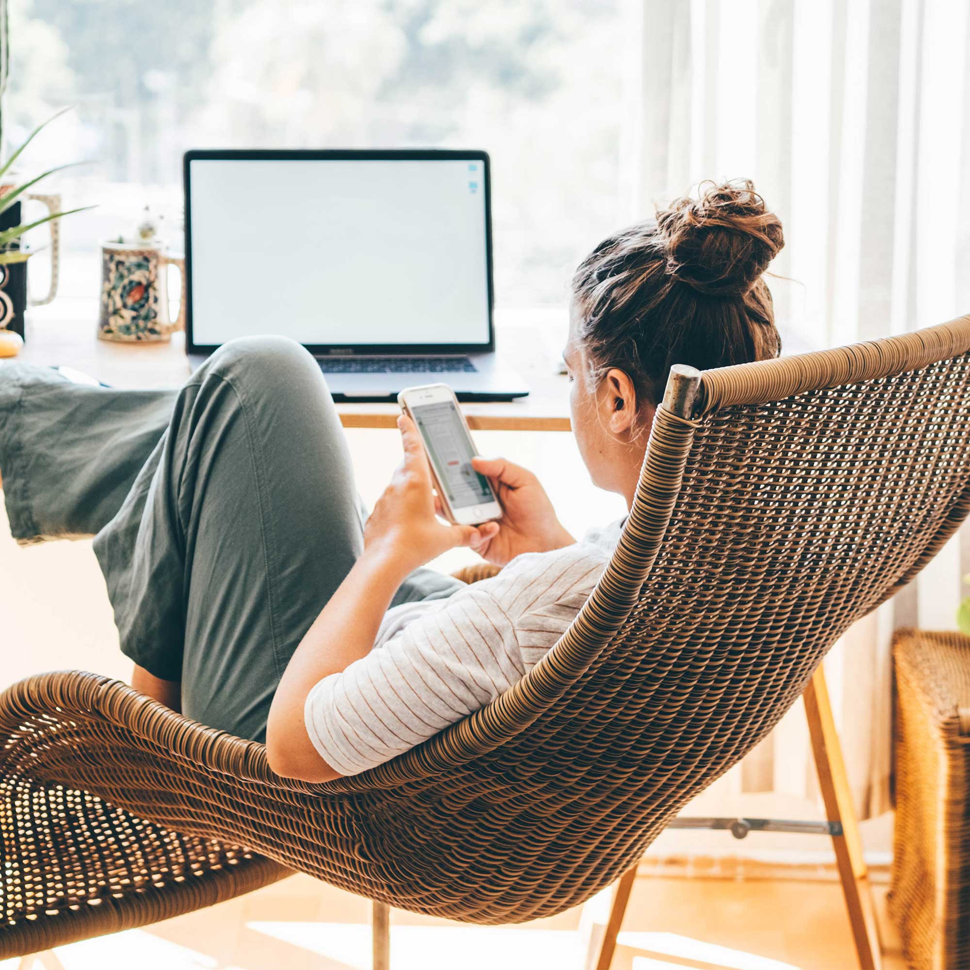 a woman sitting in a chair using a phone