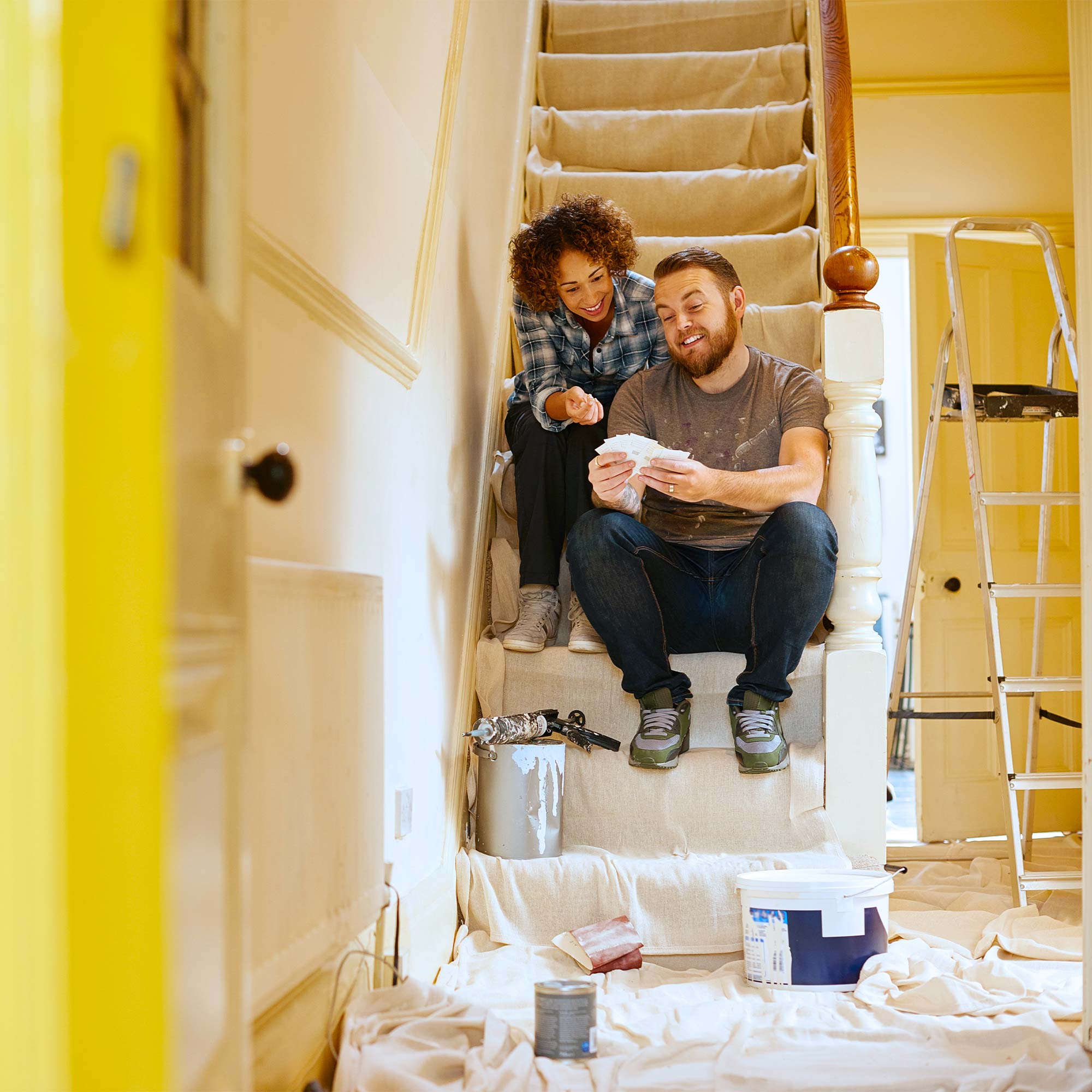 a man and woman sitting on stairs