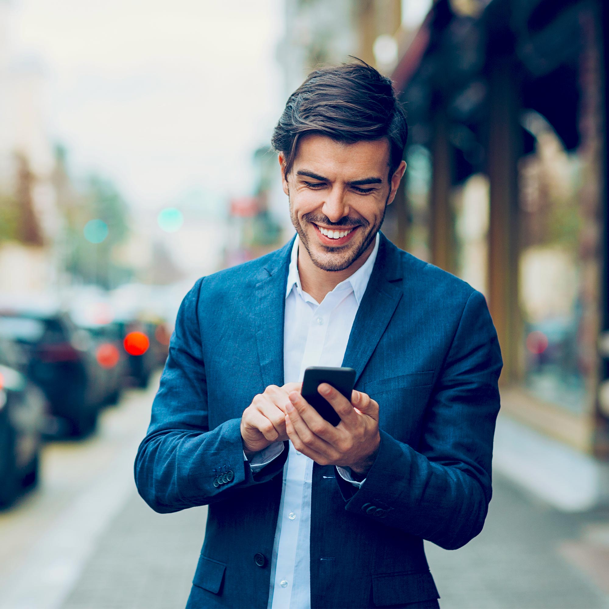 a man in a suit looking at a phone