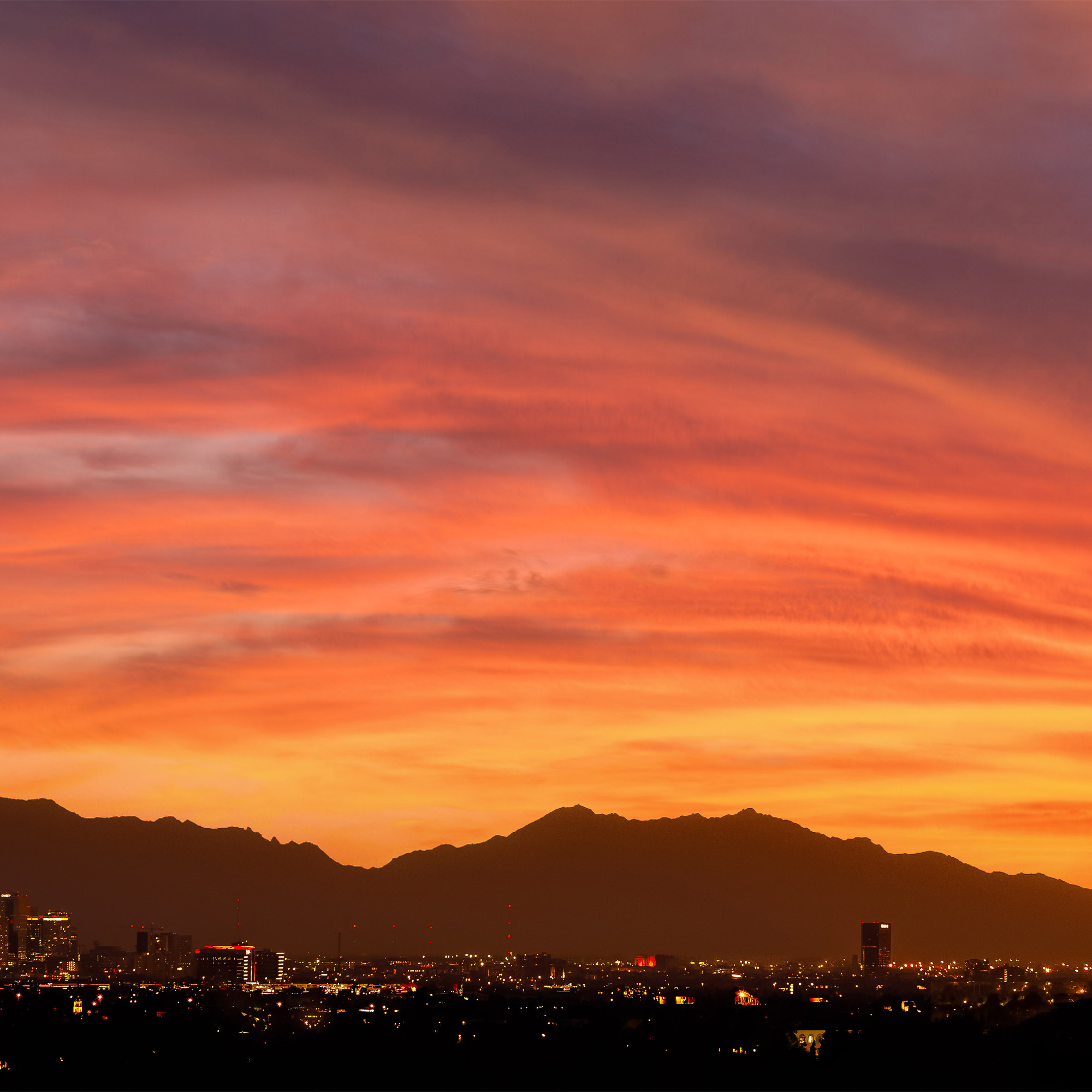 a cityscape with mountains in the background