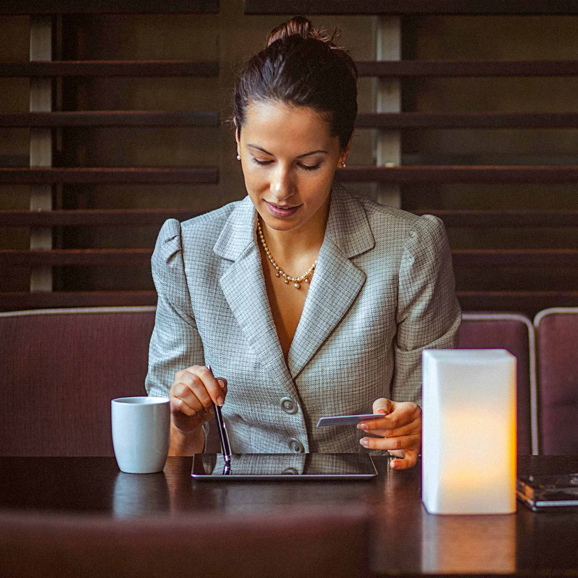 a man in a suit looking at a tablet