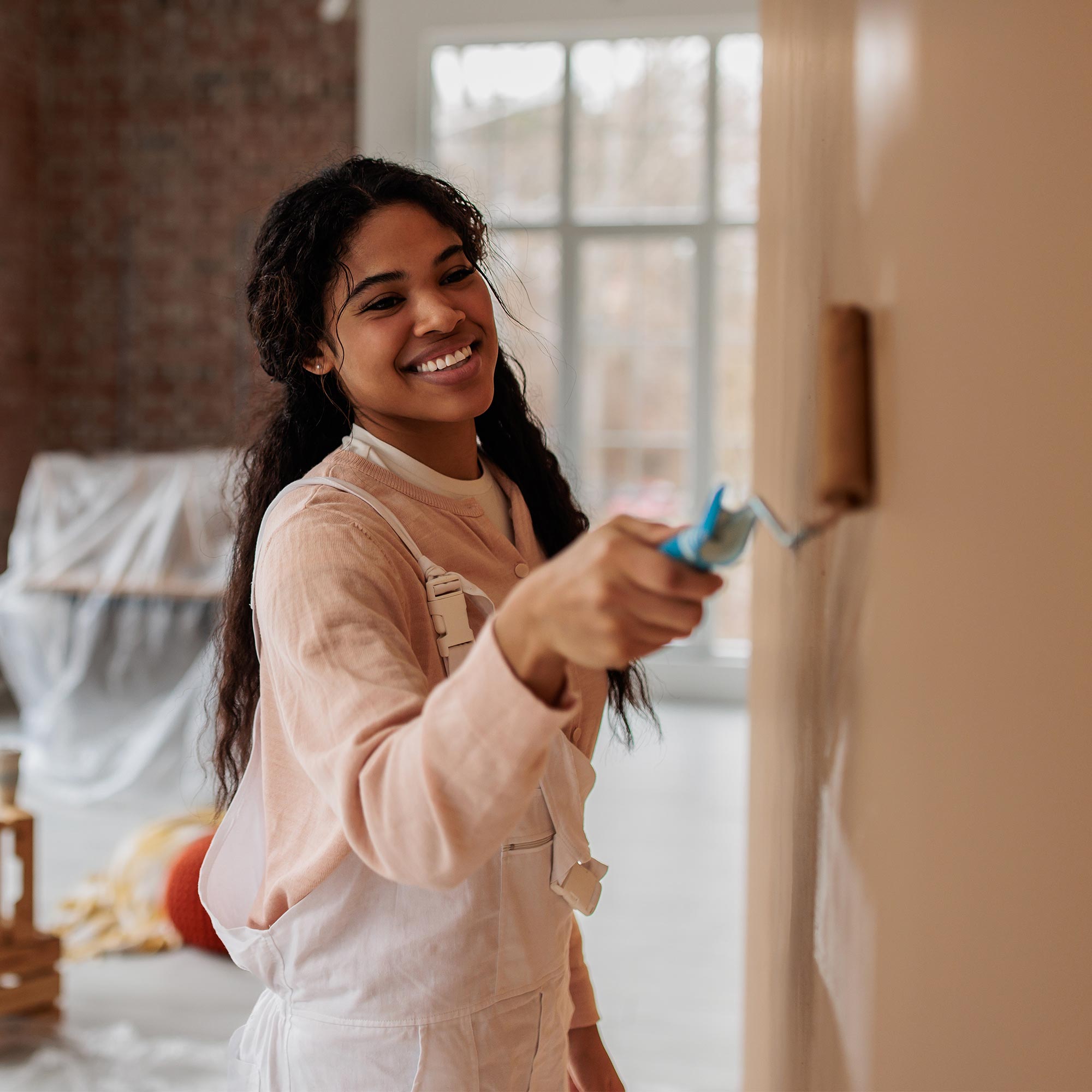 a woman painting a wall