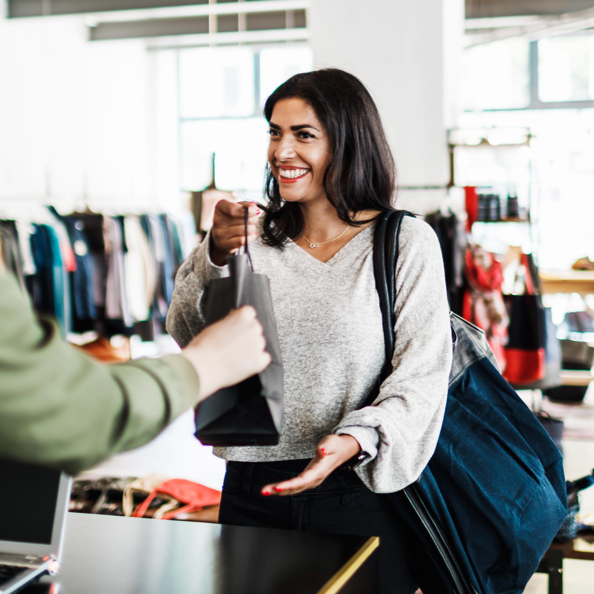 a woman handing a bag to a man