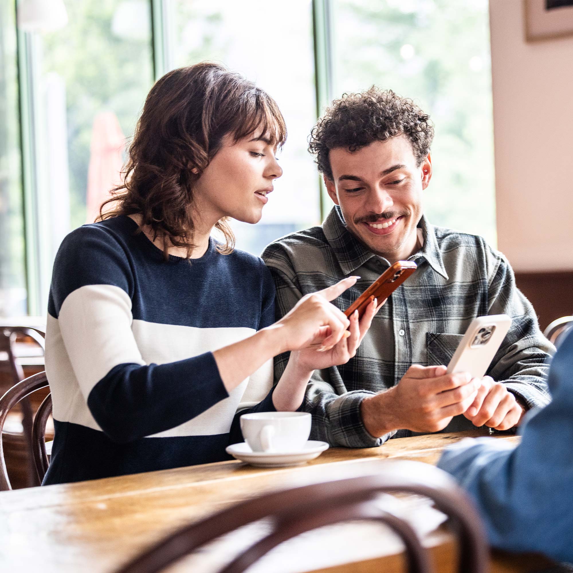a man and woman looking at a phone