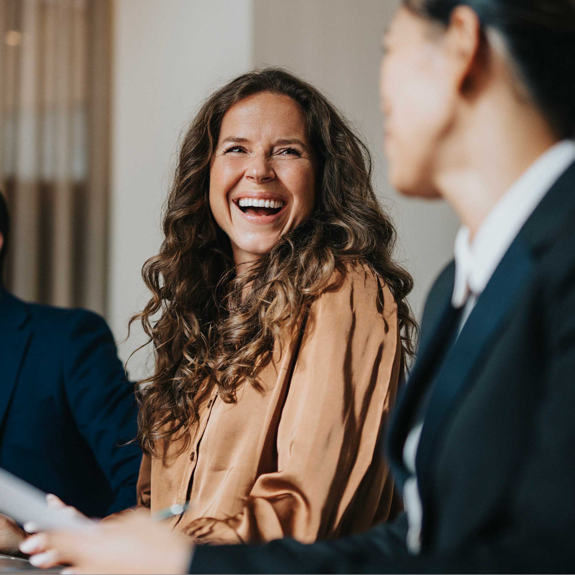 a woman laughing at another woman