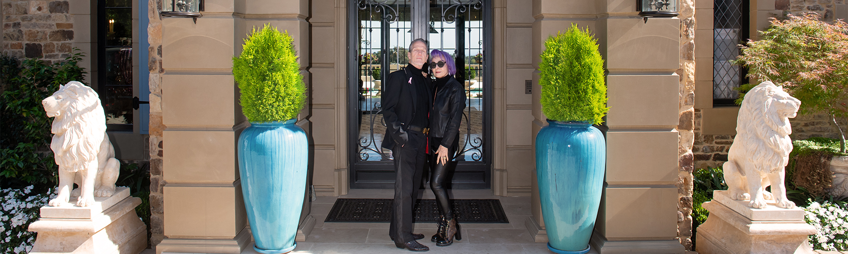 a man and woman standing in front of a door