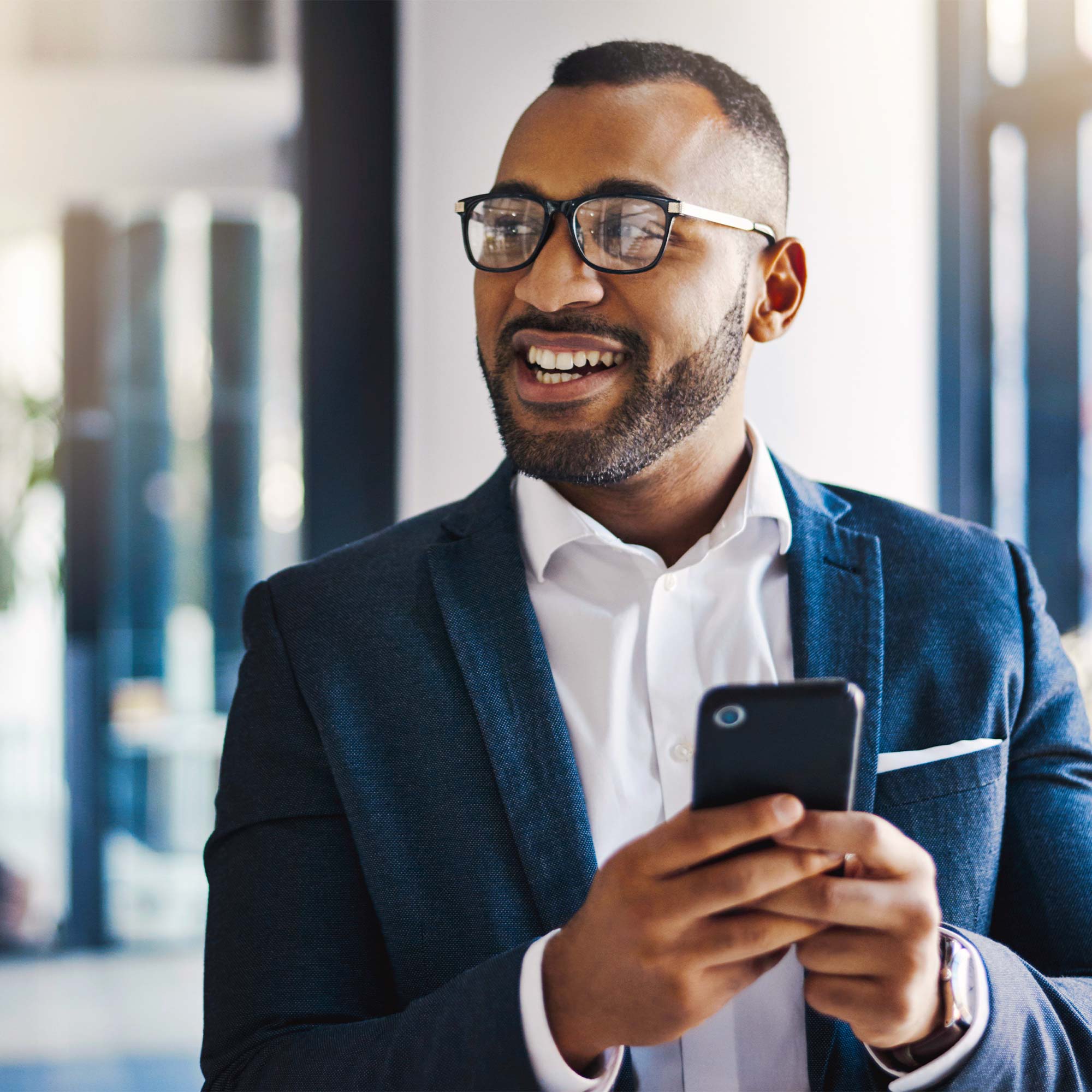 a man in a suit looking at a phone