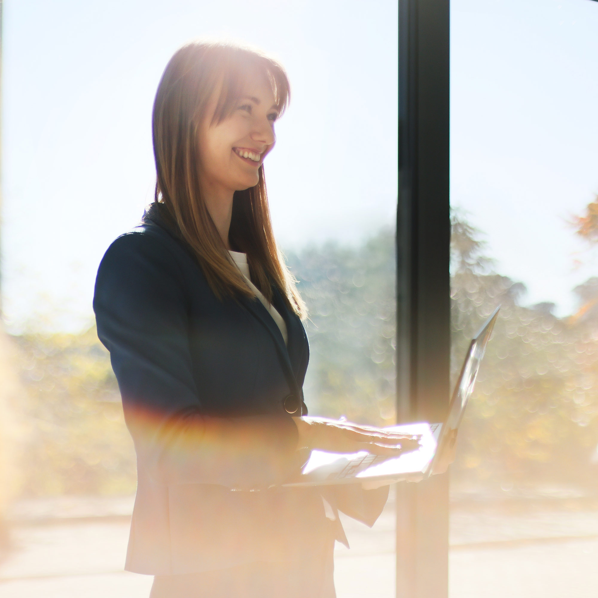 a woman standing in front of a window