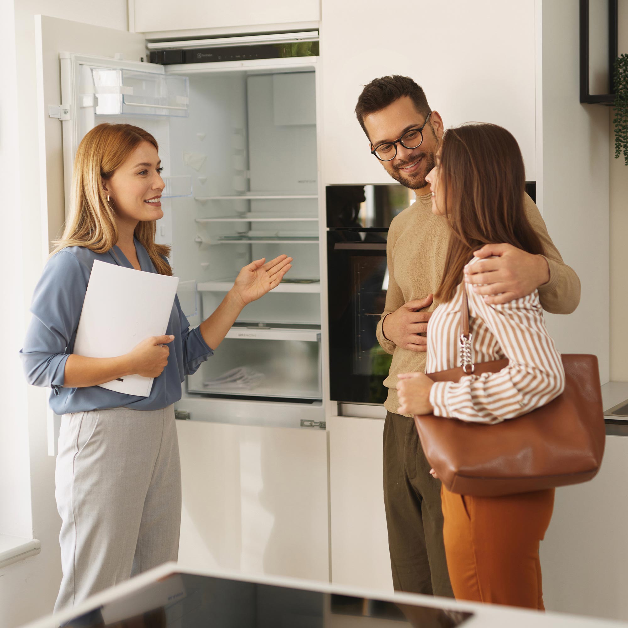 a group of people standing in a kitchen