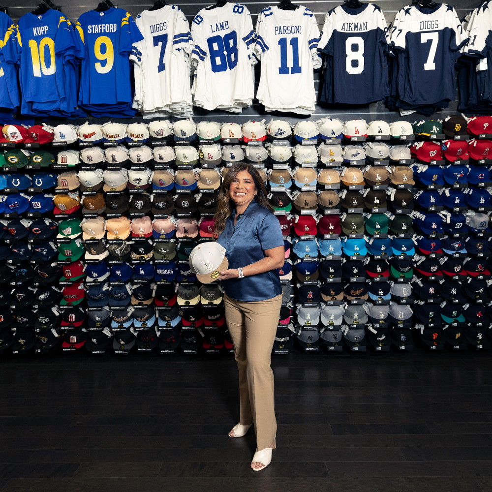 a woman standing in front of a wall of sports jerseys