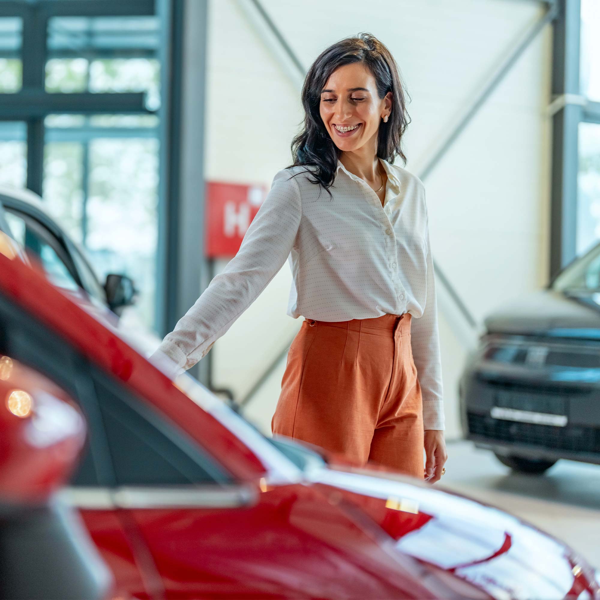 a woman smiling at a car