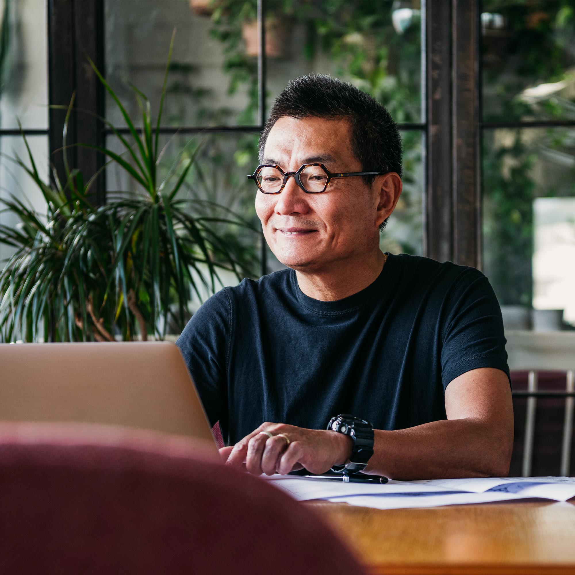 a man sitting at a table with a laptop