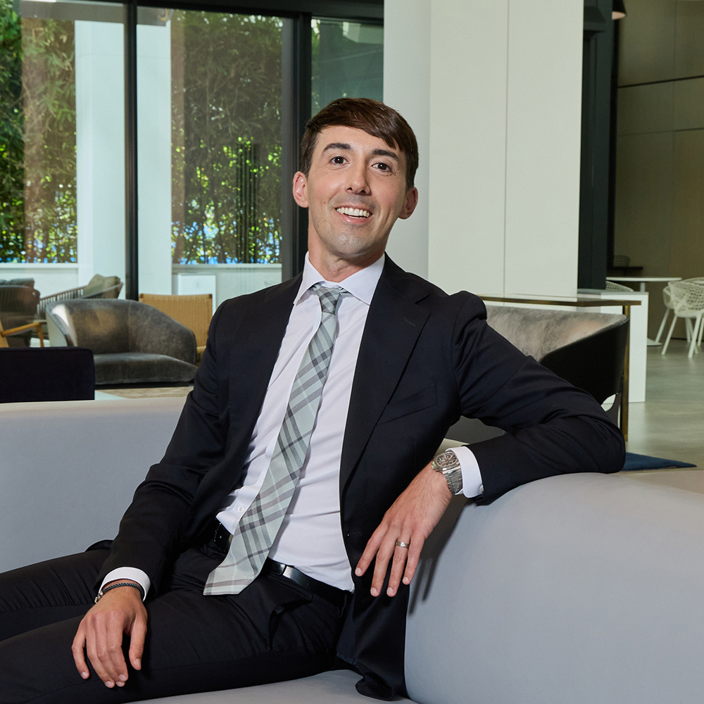 a man in a suit sitting on a couch