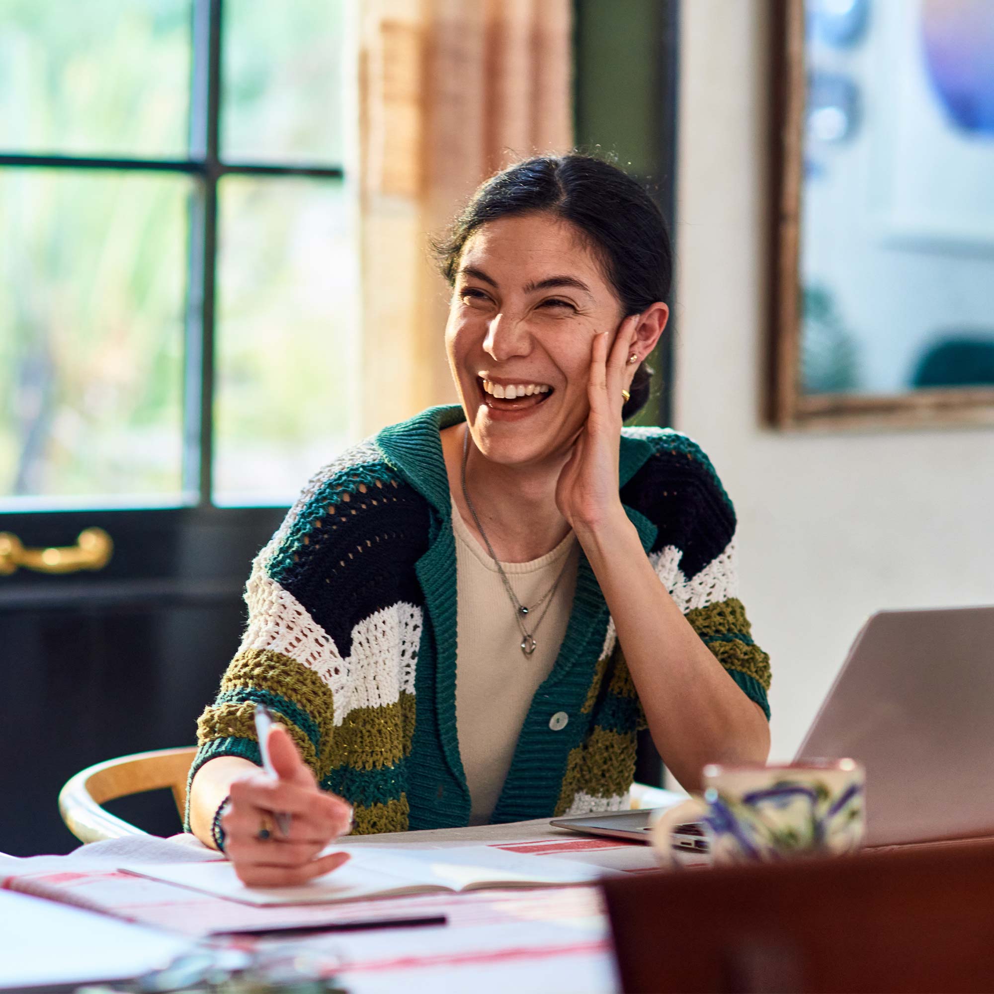 a woman laughing at a table