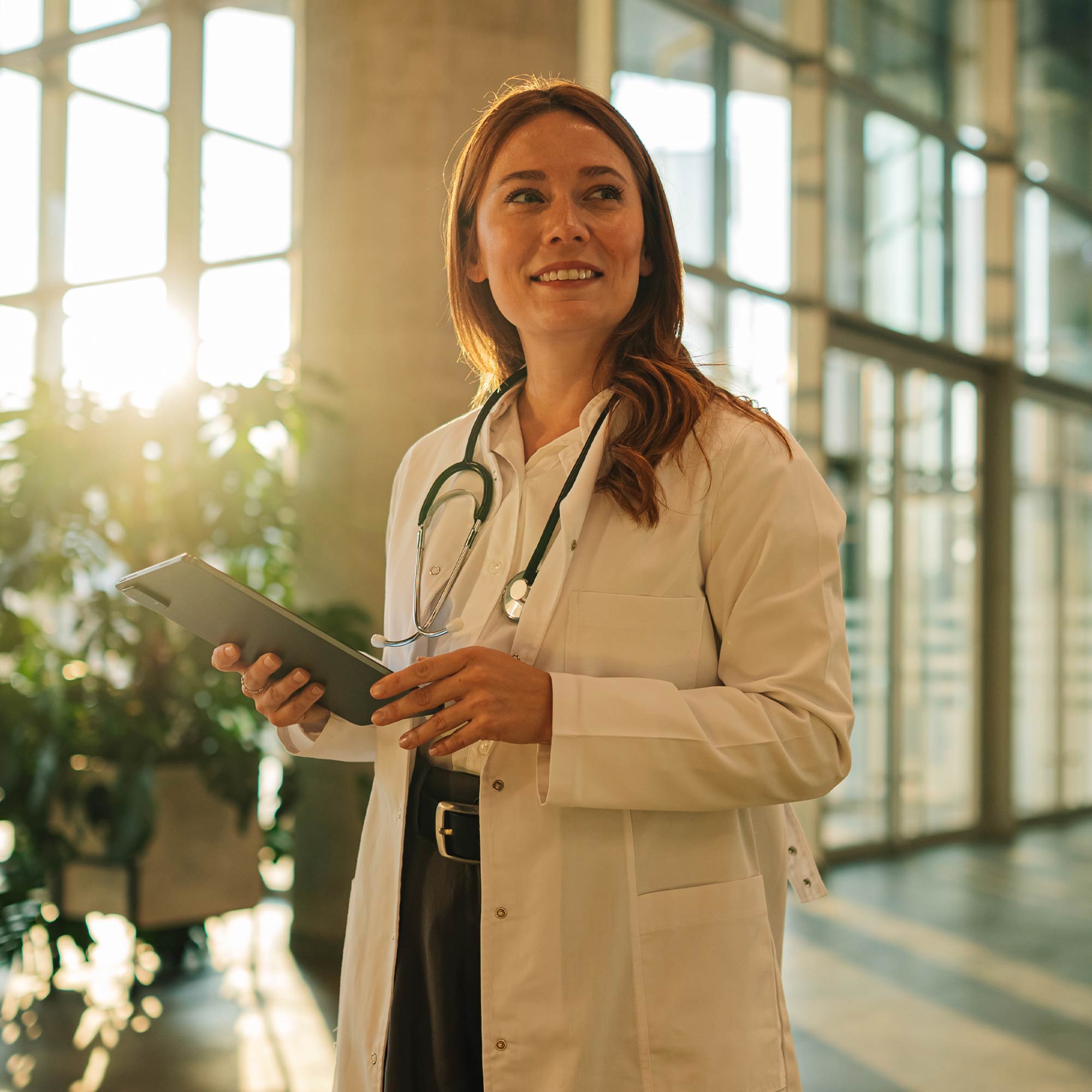 a woman in a white coat holding a clipboard