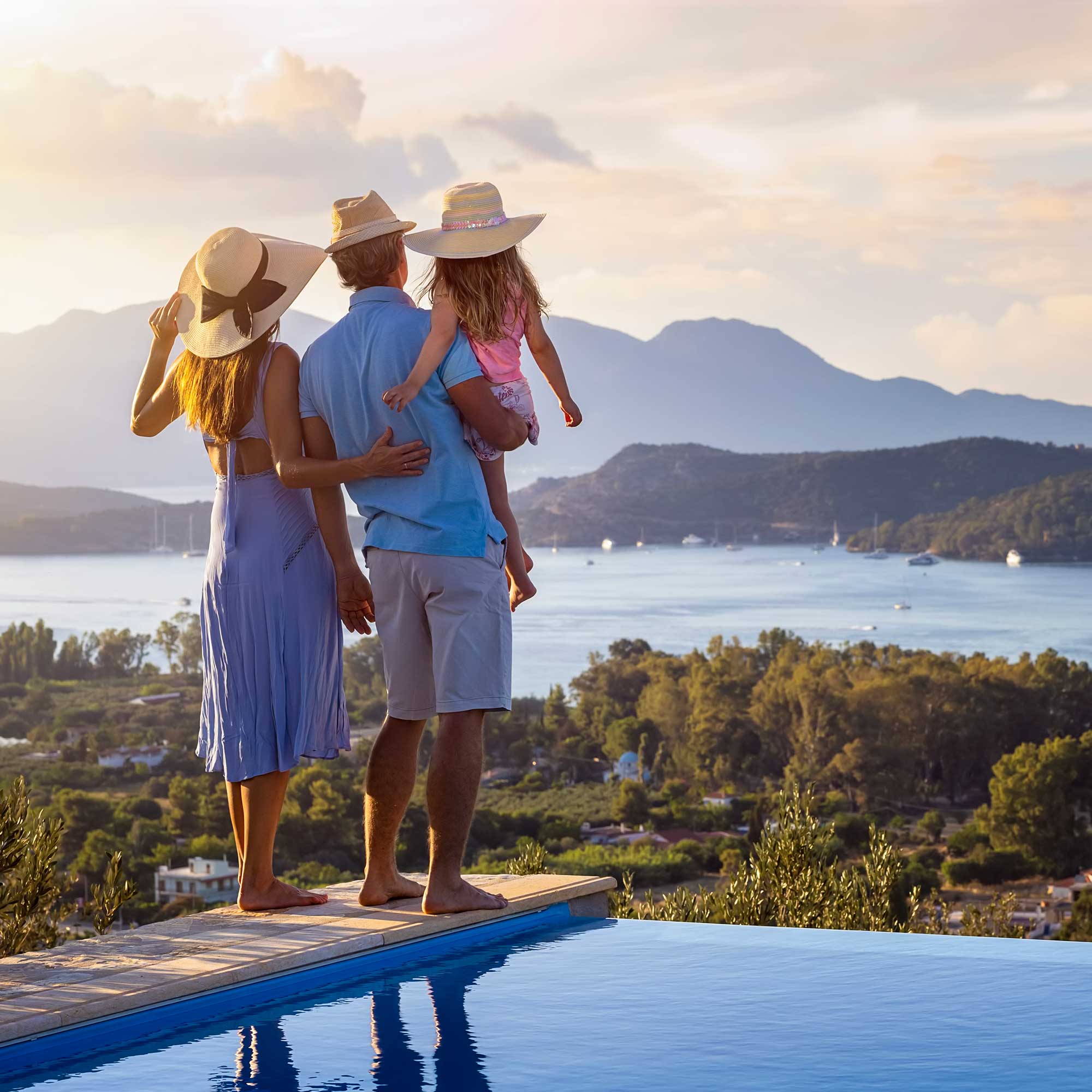 a group of people standing on a ledge overlooking a body of water