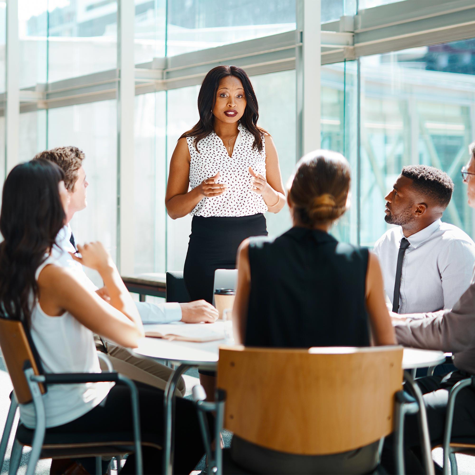 a woman standing in front of a group of people