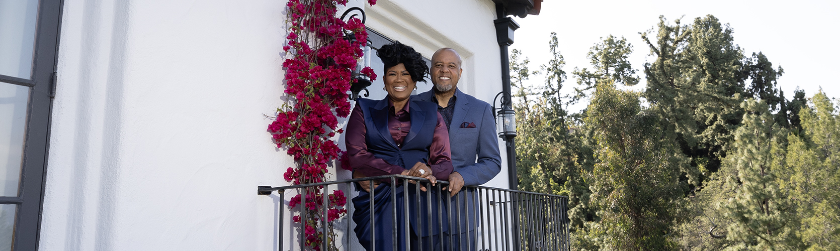 a man and woman standing on a balcony