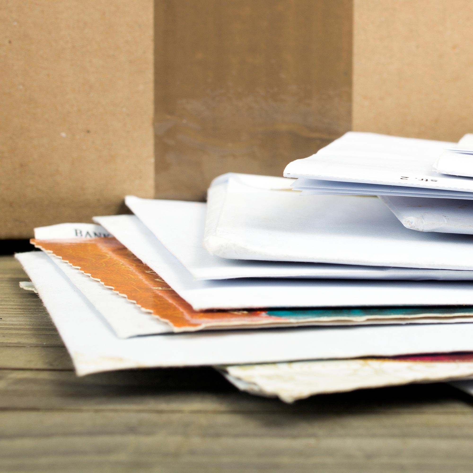 a stack of papers on a wood surface