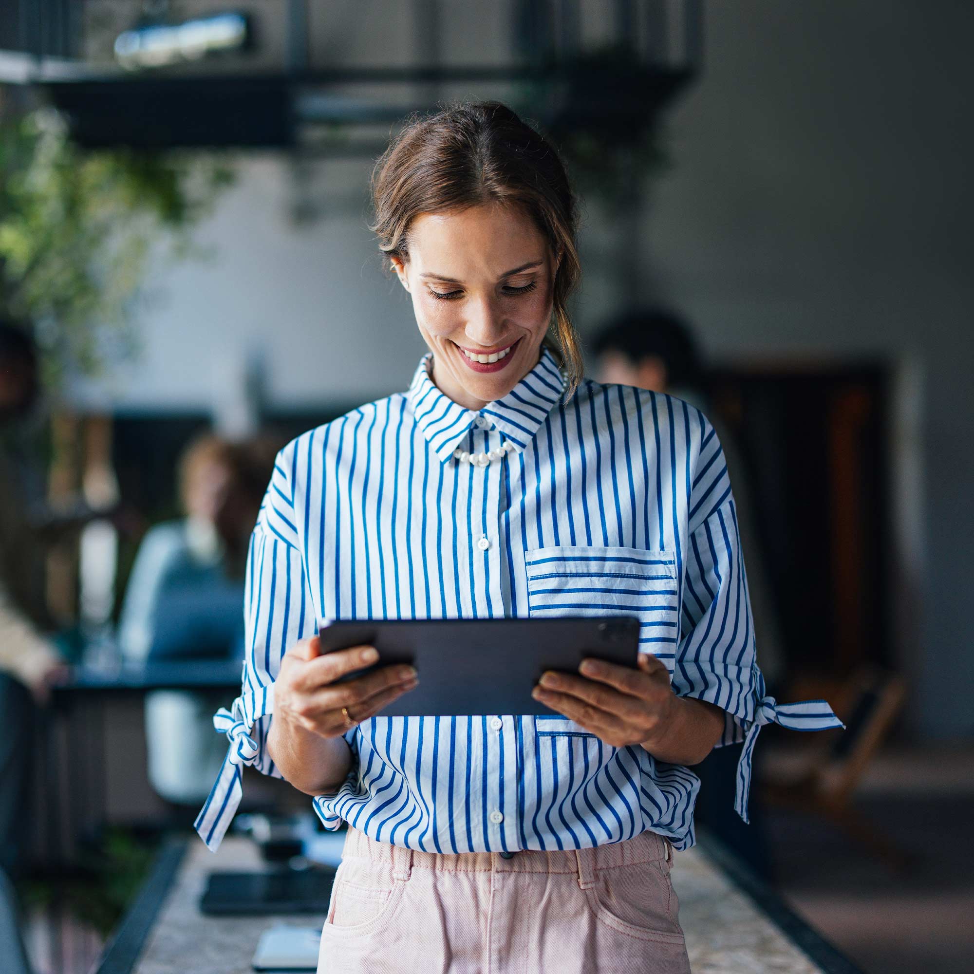 a woman holding a tablet