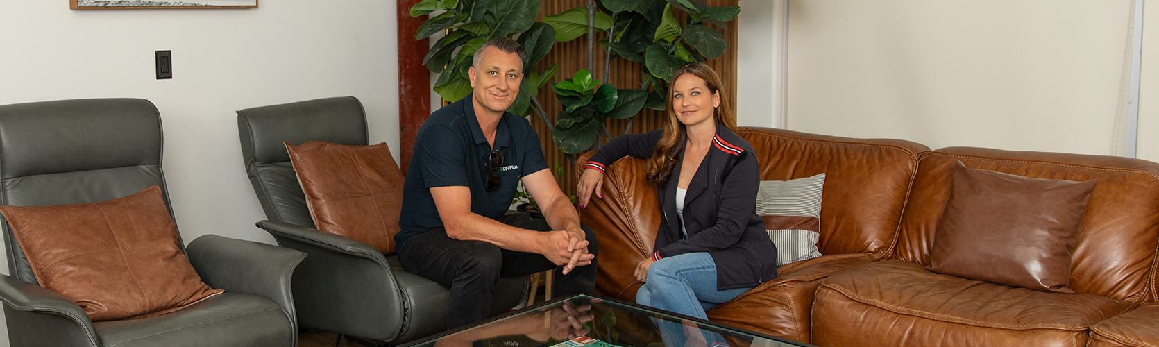 a man and woman sitting on leather chairs