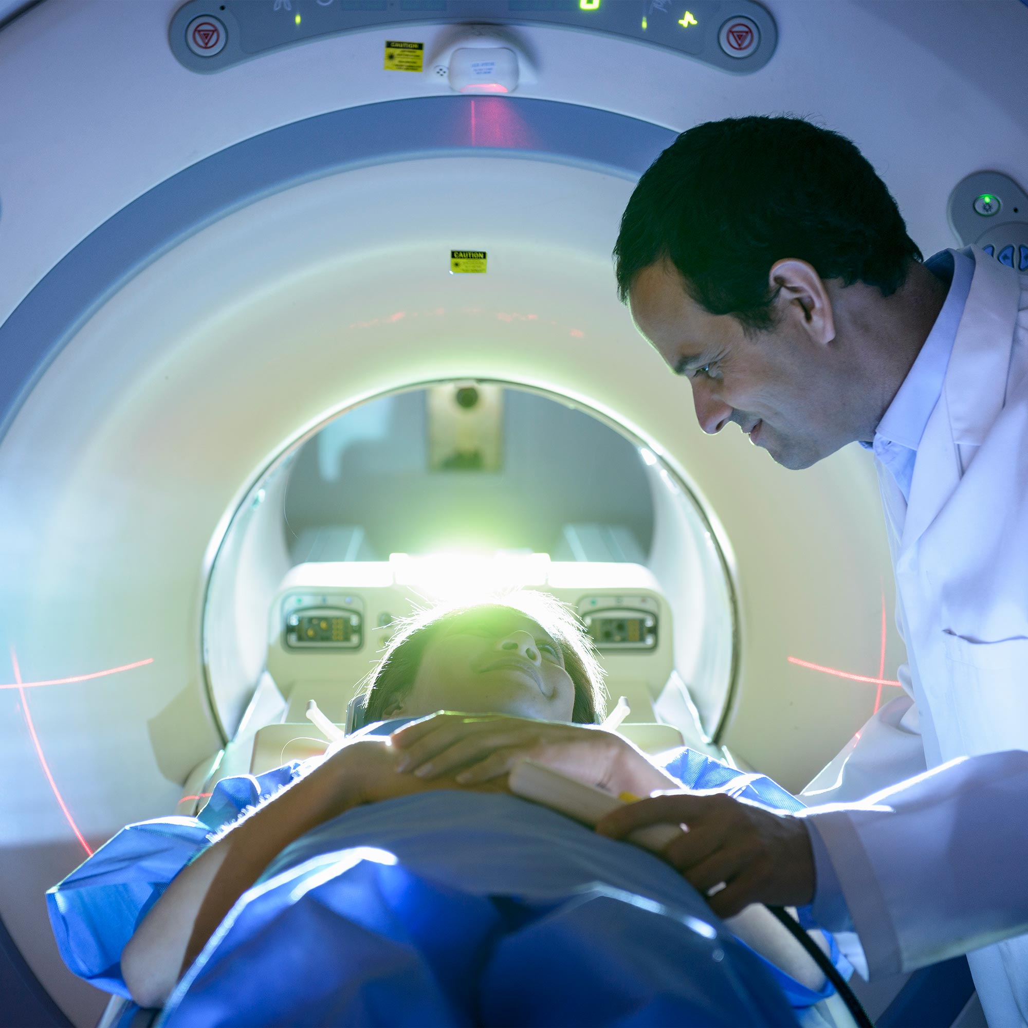a man in a white coat looking at a patient