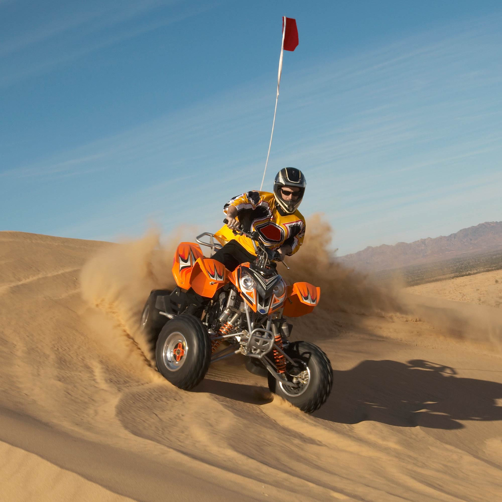 a person on a four wheeler in the sand