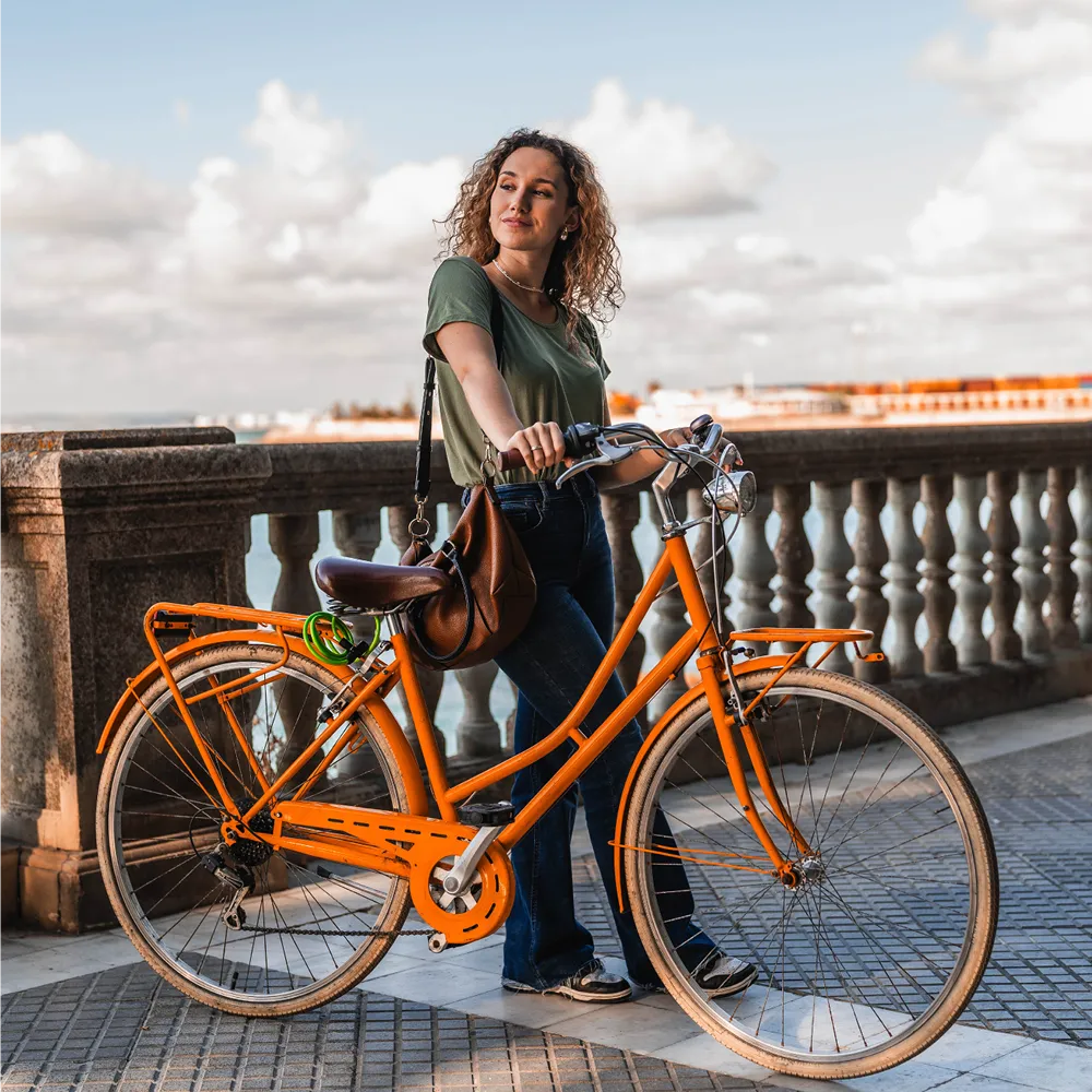 woman standing next to a bike outdoors woman standing next to a bike outdoors
