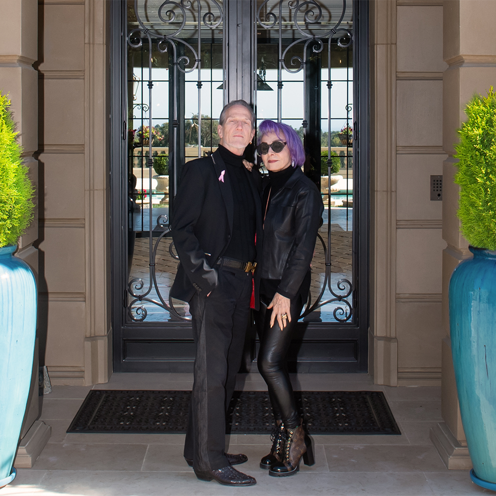 a man and woman standing in front of a door