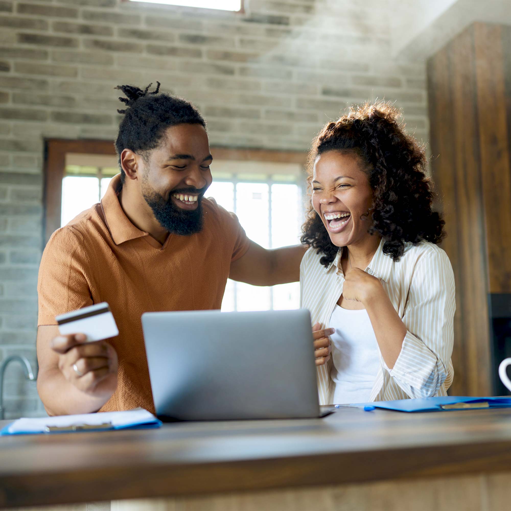 a man and woman looking at a laptop