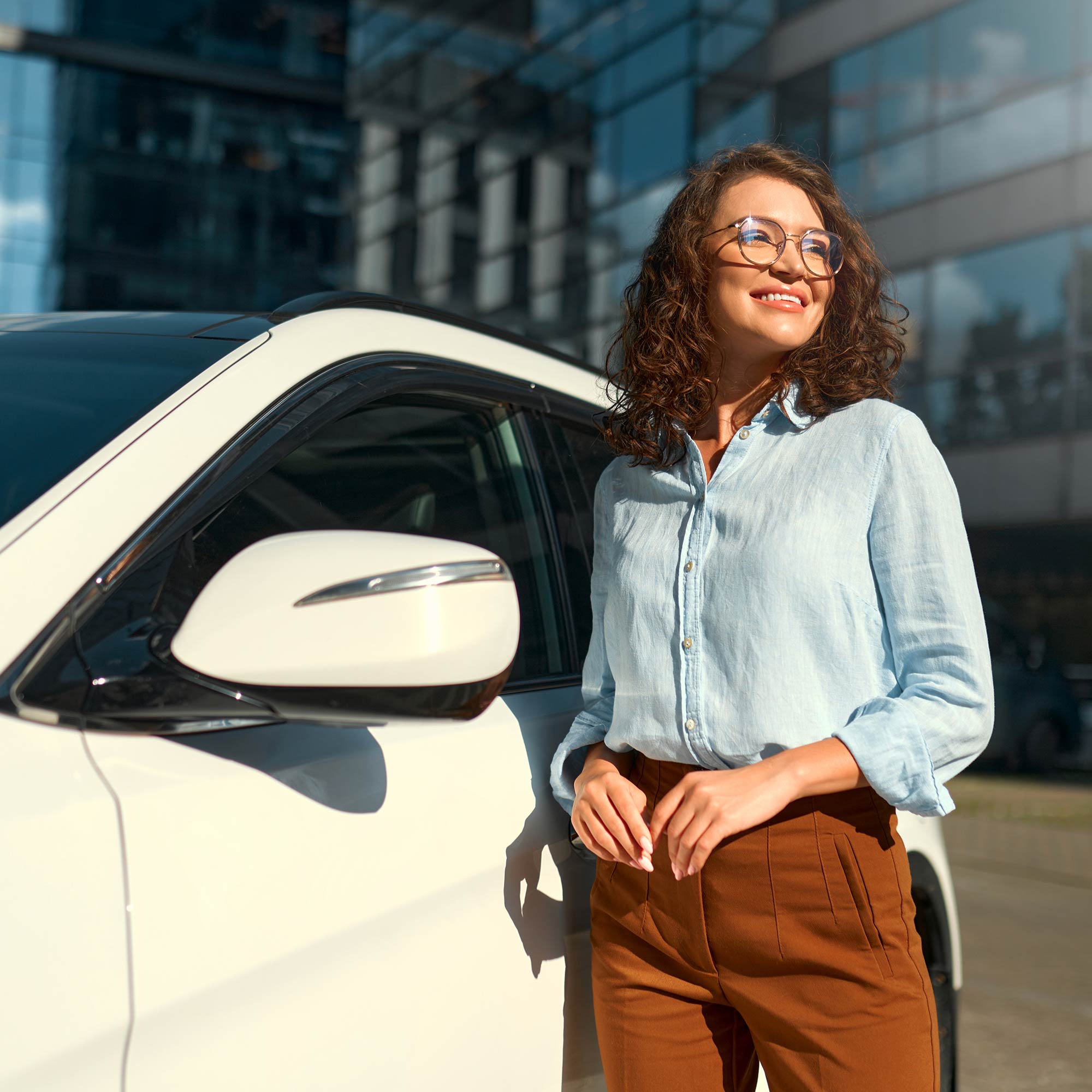 a woman standing next to a car