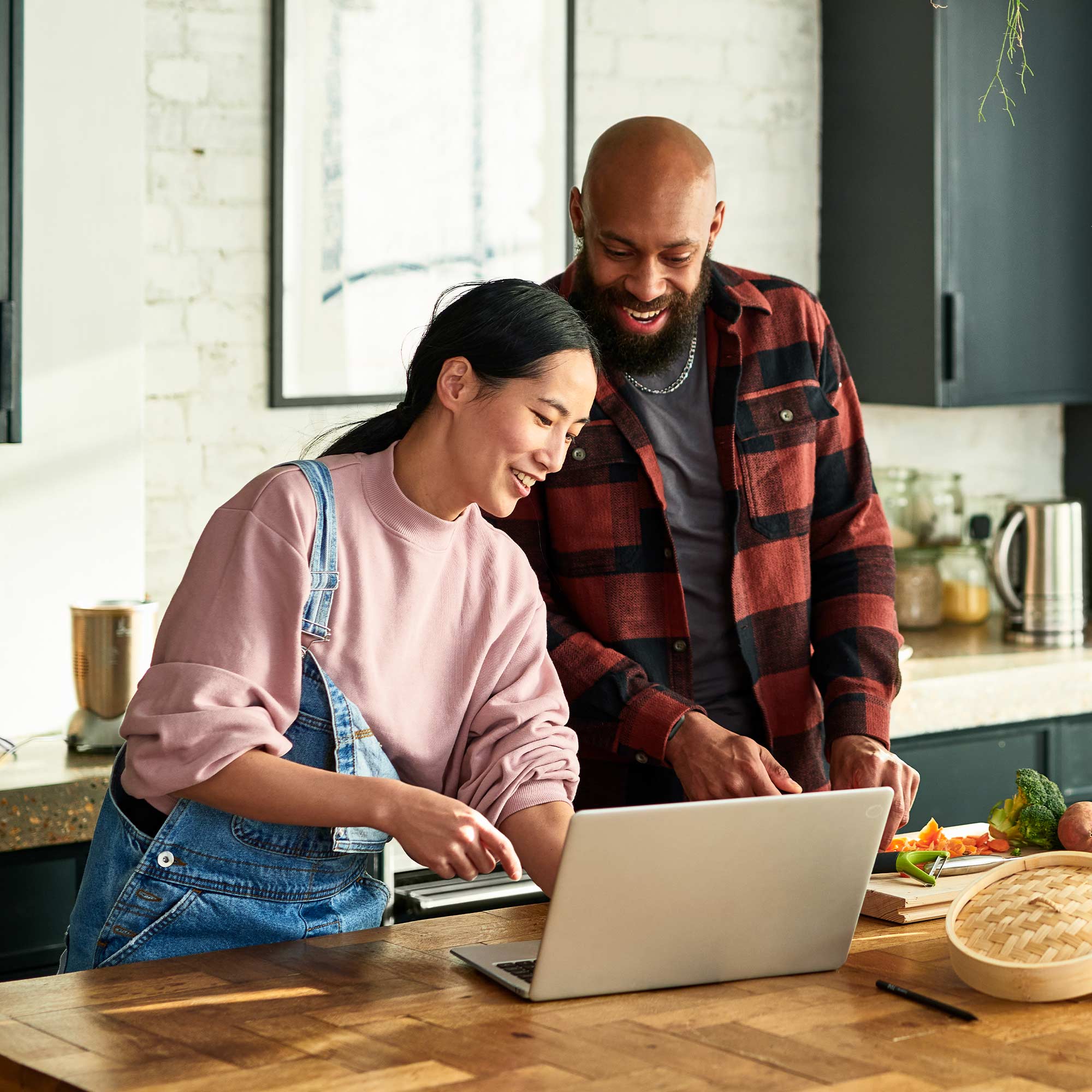 a man and woman looking at a laptop