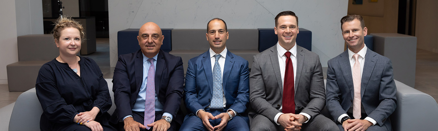 a group of men in suits sitting on a couch