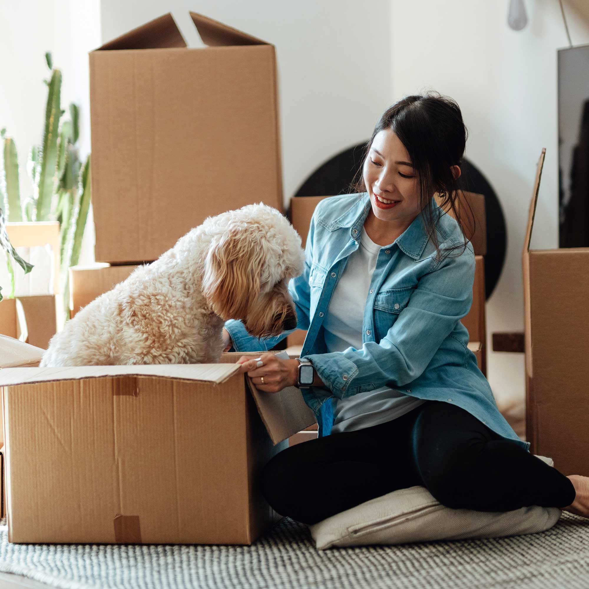 a woman and a dog in a box